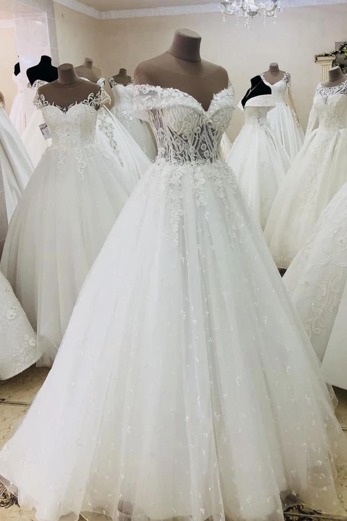 Vestido de novia largo transparente con hombros descubiertos y apliques